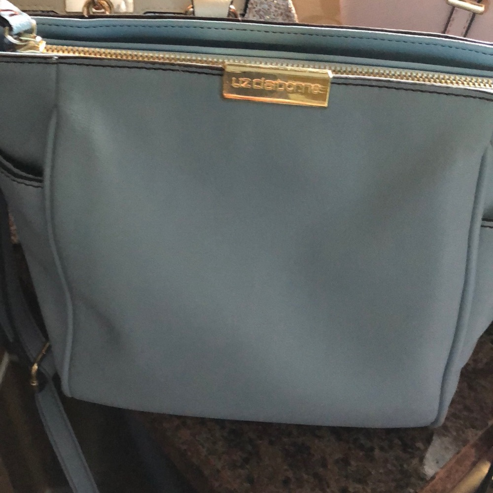 A light blue strap purse